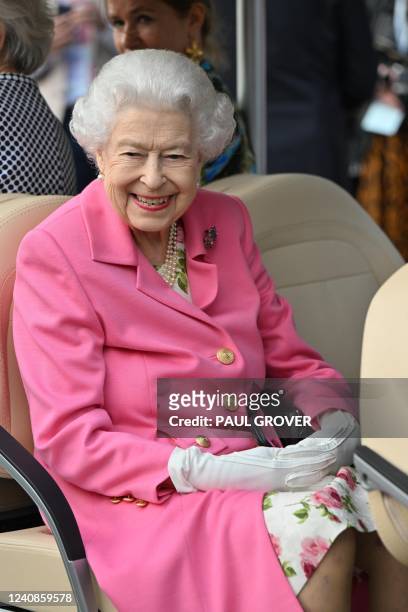 Britain's Queen Elizabeth II smiles during a visit to the 2022 RHS Chelsea Flower Show in London on May 23, 2022. The Chelsea flower show is held...