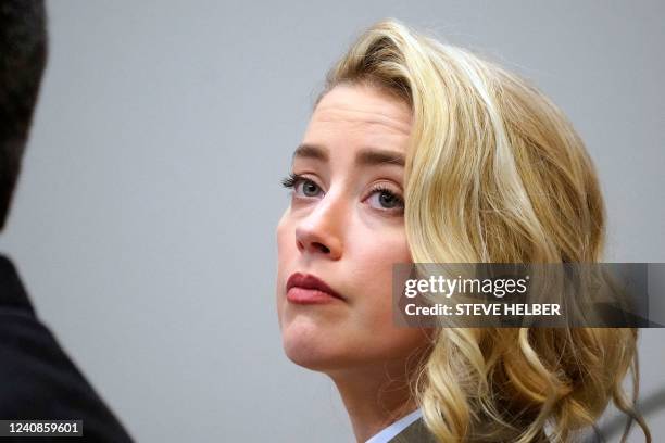 Actress Amber Heard listens in the courtroom at the Fairfax County Circuit Courthouse in Fairfax, Virginia, on May 23, 2022. - US actor Johnny Depp...