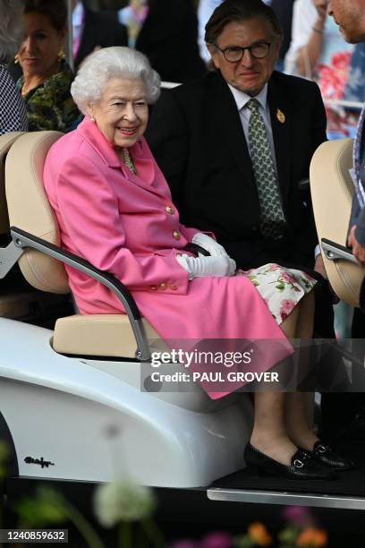 Britain's Queen Elizabeth II smiles during a visit to the 2022 RHS Chelsea Flower Show in London on May 23, 2022. The Chelsea flower show is held...