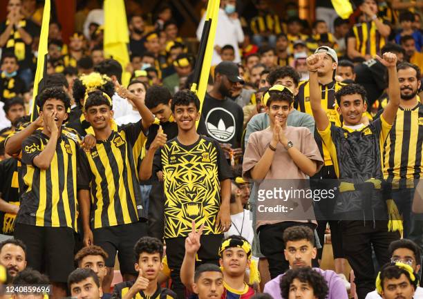 Ittihad supporters cheer ahead of the Saudi Pro League football match between al-Ittihad and al-Hilal at the King Abdullah Sports City in Jeddah on...