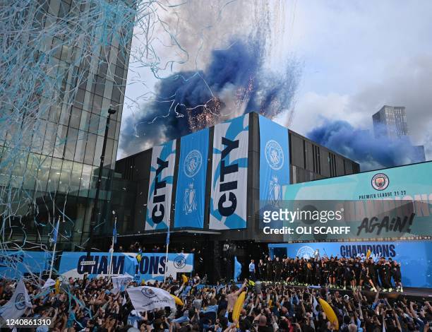Manchester City's players attend an event for fans with members of the Manchester City football team following an open-top bus parade through...