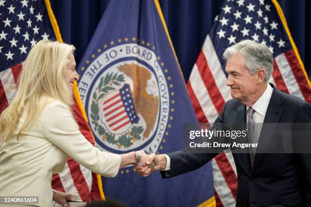 Vice Chair of the Federal Reserve Lael Brainard shakes hands with Jerome Powell after he took the oath of office for his second term as Chair of the...
