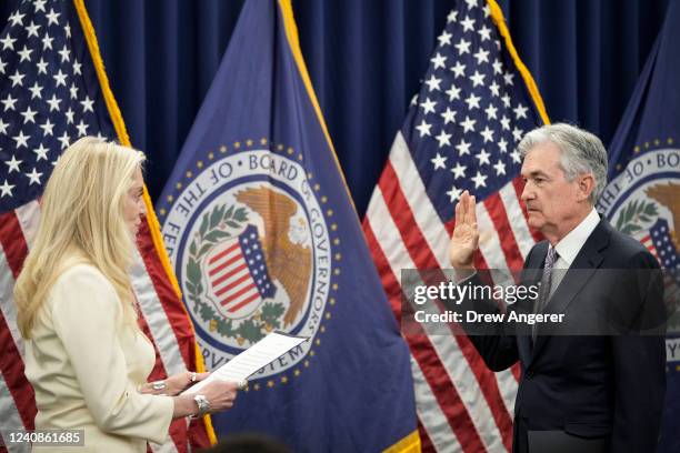 Vice Chair of the Federal Reserve Lael Brainard administers the oath of office for Jerome Powell as he participates in a swearing-in for his second...