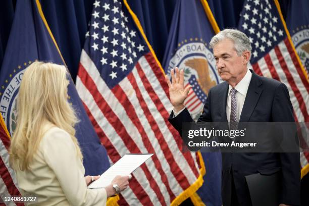 Vice Chair of the Federal Reserve Lael Brainard administers the oath of office for Jerome Powell as he participates in a swearing-in for his second...