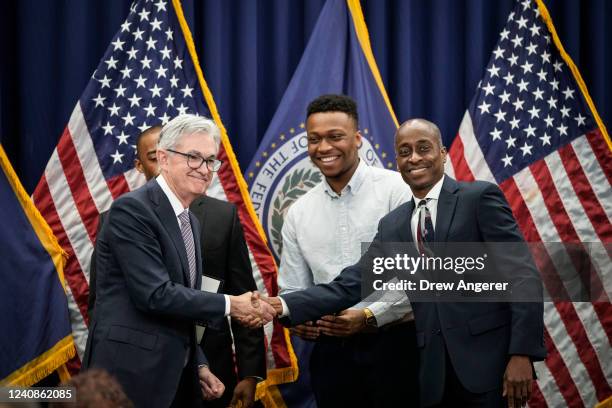 Chair of the Federal Reserve Jerome Powell shakes hands with Philip Jefferson after he took the oath of office to serve as a member of the Board of...