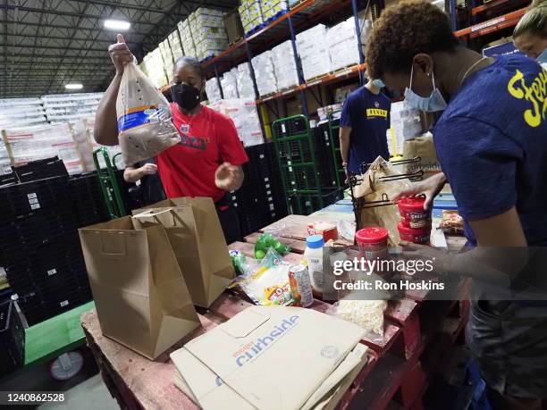Kia Vaughn of the Atlanta Dream packages food at Gleaners Food Bank May 16, 2022 in Indianapolis, Indiana. NOTE TO USER: User expressly acknowledges...