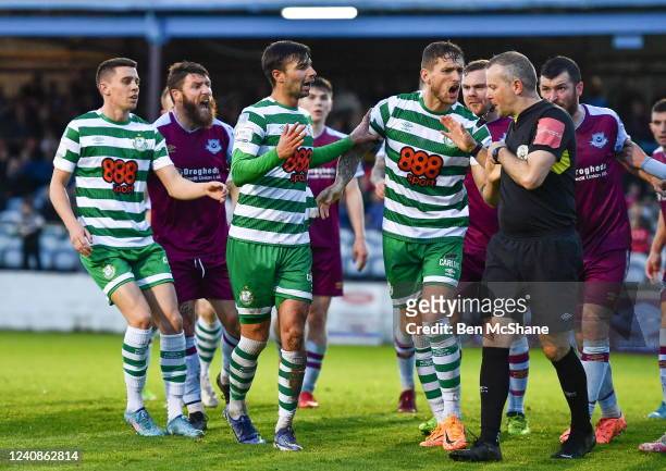 Louth , Ireland - 23 May 2022; Danny Mandroiu of Shamrock Rovers is restrained by teammate Lee Grace, right, as referee Ray Matthews makes his way to...