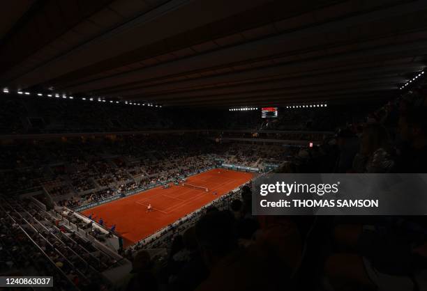 Japan's Yoshihito Nishioka returns the ball to Serbia's Novak Djokovic during their men's singles match on day two of the Roland-Garros Open tennis...