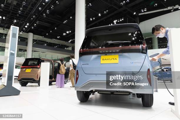 Visitors take a closer look at the new Nissan Sakura which is on display at Nissan Gallery in Yokohama, Kanagawa. Car maker Nissan presented a new EV...