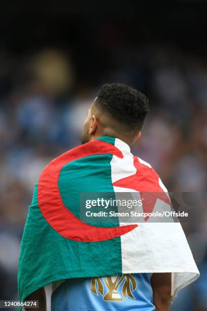 Riyad Mahrez of Manchester City wears an Algeria flag around his shoulders after the Premier League match between Manchester City and Aston Villa at...