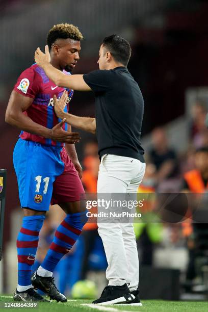 Adama Traore of Barcelona is changed and greets to Xavi Hernandez head coach of Barcelona during the LaLiga Santander match between FC Barcelona and...