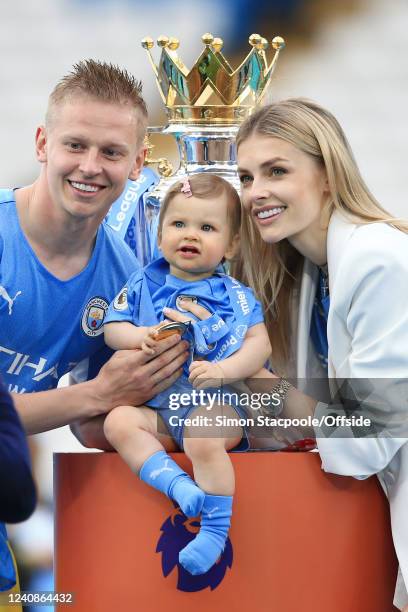 Oleksandr Zinchenko of Manchester City poses with his wife, Vlada Shcheglova, and their daughter alongside the trophy after the Premier League match...