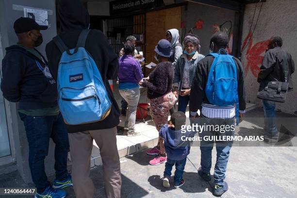 Asylum seekers, mostly from Haiti, stand outside the Espacio Migrante community centre as they seek for medical attention, in Tijuana, Baja...