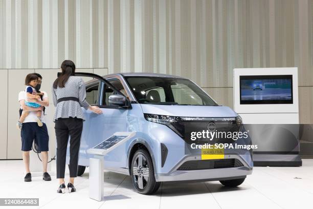 Visitors take a closer look at the new Nissan Sakura which is on display at Nissan Gallery in Yokohama, Kanagawa. Car maker Nissan presented a new EV...