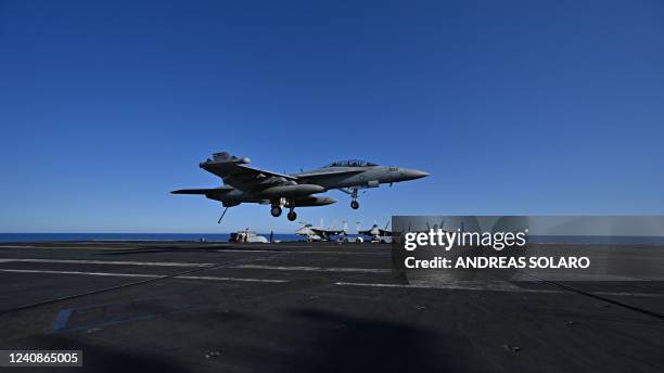 An F/A-18 Hornet fighter jet landing on the deck of the US Nimitz-class nuclear-powered aircraft carrier USS Harry S. Truman, during a NATO vigilance...