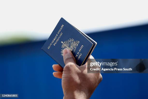An immigrant from Haiti shows his passport at the "Senda de Vida" shelter in order to travel on May 23, 2022 in Reynosa, Mexico. Title 42, the...