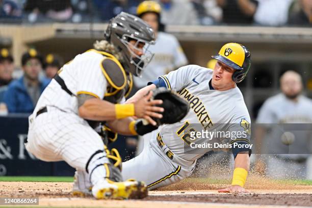Hunter Renfroe of the Milwaukee Brewers scores ahead of the throw to Jorge Alfaro of the San Diego Padres during the second inning on May 23, 2022 at...