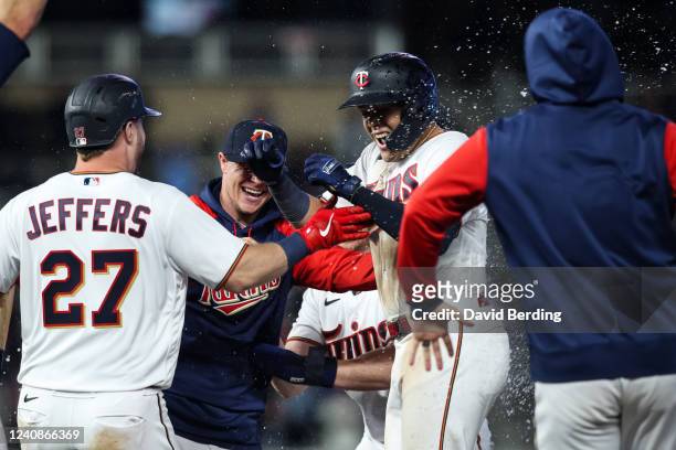 Gio Urshela of the Minnesota Twins celebrates his walk-off infield single against the Detroit Tigers with teammates at Target Field on May 23, 2022...