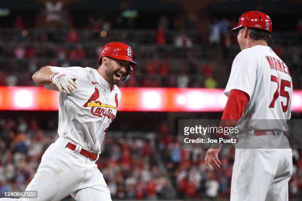 Paul Goldschmidt of the St. Louis Cardinals is congratulated by Ron Pop' Warner of the St. Louis Cardinals after hitting a walk-off grand slam...