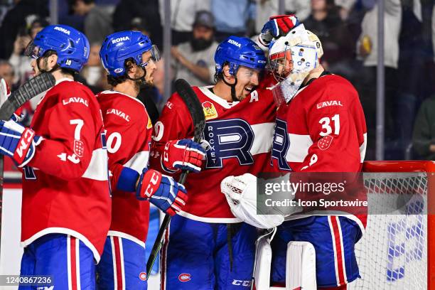 Laval Rocket goalie Cayden Primeau celebrates the win with his teammates during the game 2 of round 3 of the Calder Cup Playoffs between the...