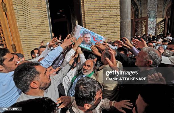 Mourners carry the coffin of Iran's Revolutionary Guards colonel Sayyad Khodai during a funeral procession at Imam Hussein square in the capital...