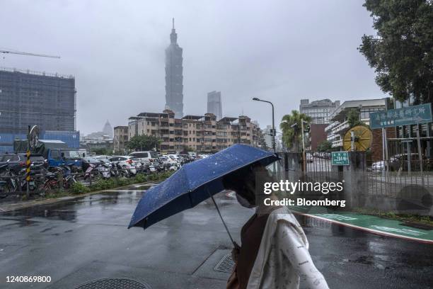 Pedestrian passes the Taipei 101 building in Taipei, Taiwan, on Tuesday, May 24, 2022. US President Joe Biden is seeking to show US resolve against...