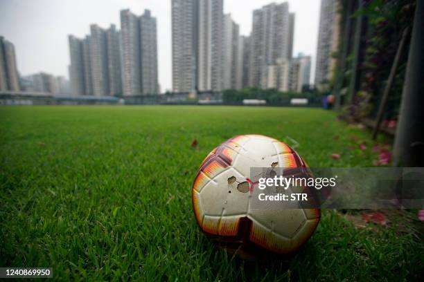 Football is seen on the pitch of Chongqing Liangjiang Athletic football club in southwest China's Chongqing on May 24, 2022. - Top-tier Chinese...