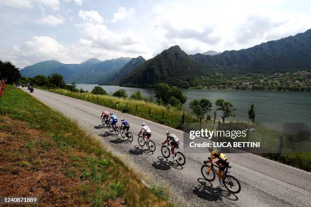 Riders race past Lake Garda during the 16th stage of the Giro d'Italia 2022 cycling race, 177 kilometers from Salo' to Aprica, on May 24, 2022.