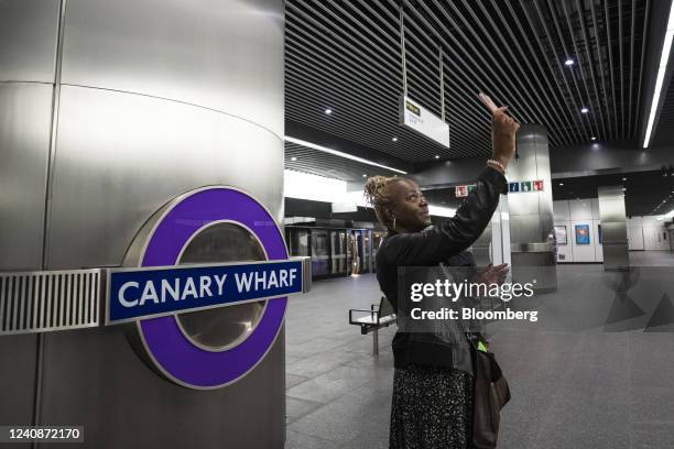 Passenger takes a mobile phone photo on the opening day of the new Elizabeth Line at Canary Wharf station in London, UK, on Tuesday, May 24, 2022....