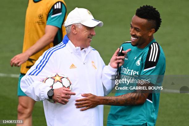 Real Madrid's Italian coach Carlo Ancelotti jokes with Real Madrid's Brazilian defender Eder Militao during a training session at the Ciudad Real...