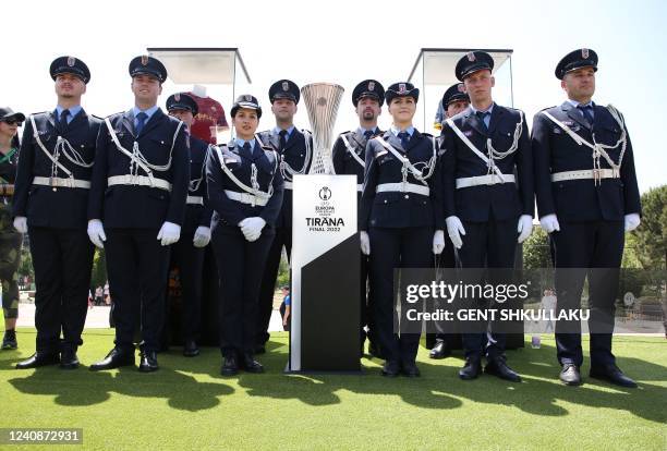 City police pose for a photograph with the UEFA Europa Conference League trophy during its presentation at Tirana's main square on May 24 on the eve...