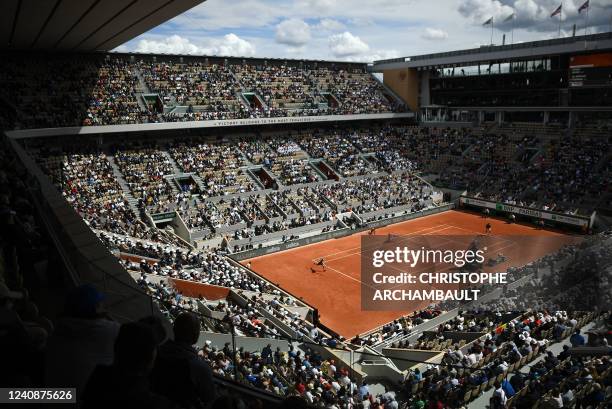 Norway's Casper Ruud returns the ball to France's Jo-Wilfried Tsonga during their men's singles match on day three of the Roland-Garros Open tennis...