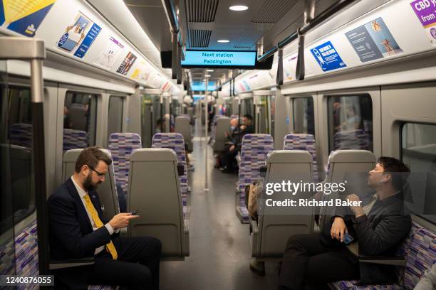 Passengers and commuters experience new trains on the day that the capital's Elizabeth Line finally opens, on 24th May 2022, in London, England. The...