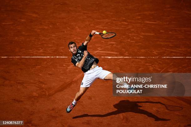 France's Hugo Gaston returns the ball to Australia's Alex De Minaur during their men's singles match on day three of the Roland-Garros Open tennis...