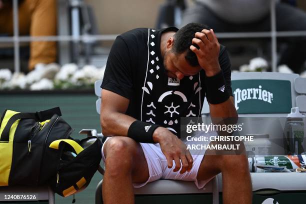 France's Jo-Wilfried Tsonga reacts before receiving medical treatment as he plays against to Norway's Casper Ruud during their men's singles match on...