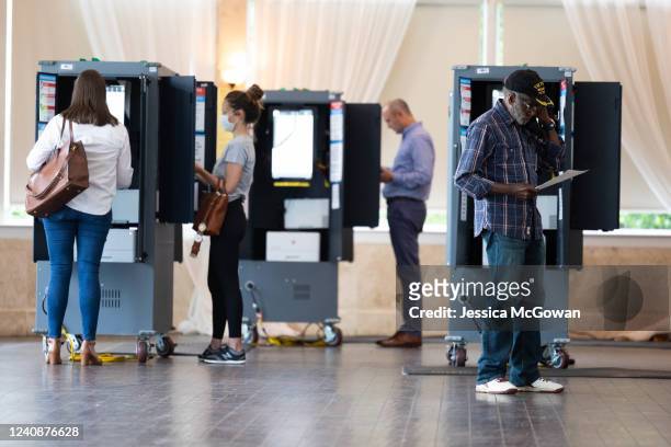 During the Georgia primary election, a voter checks his printed ballot at the Park Tavern polling location on May 24, 2022 in Atlanta, Georgia....