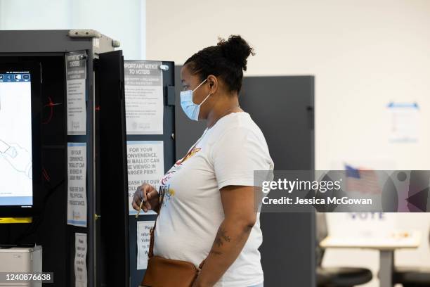 Voter casts their ballot at the Metropolitan Library polling location on May 24, 2022 in Atlanta, Georgia. Voters across Georgia will be voting on...