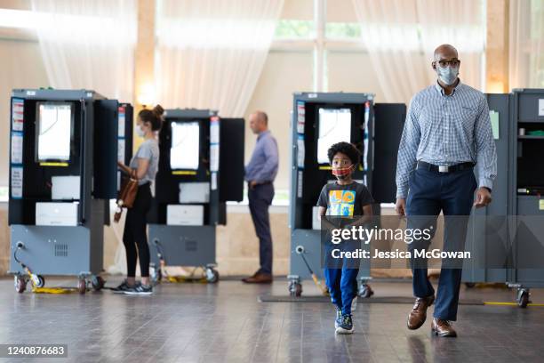 Voter and his son leave the Park Tavern polling location after casting a vote in the Georgia primary election on May 24, 2022 in Atlanta, Georgia....