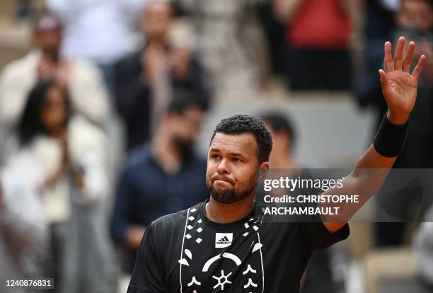 France's Jo-Wilfried Tsonga waves after losing against Norway's Casper Ruud at the end of their men's singles match on day three of the Roland-Garros...