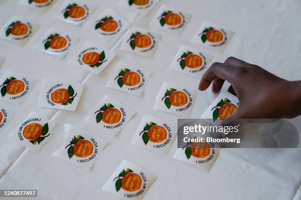 Voter picks up an "I Secured My Vote" sticker after casting a ballot at a polling location in Atlanta, Georgia, US, on Tuesday, May 24, 2022. The...