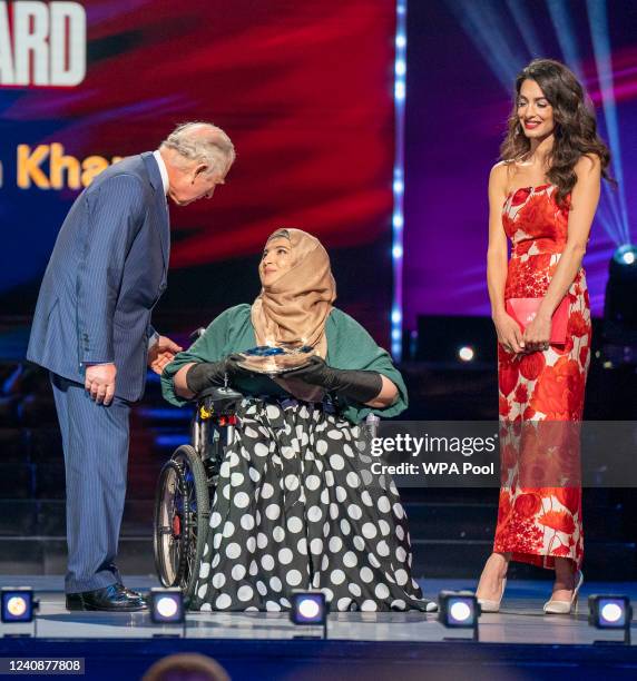 Prince Charles, Prince of Wales and Amal Clooney with Women's Empowerment Award winner Tanzila Khan on stage at The Prince's Trust TK Maxx And...