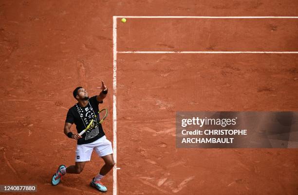 France's Jo-Wilfried Tsonga serves to Norway's Casper Ruud during their men's singles match on day three of the Roland-Garros Open tennis tournament...