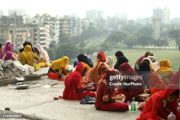 Women RMG workers are having their meal during launch break on the rooftop of a garment they work in Dhaka, Bangladesh on 24 May 2022. Female workers...