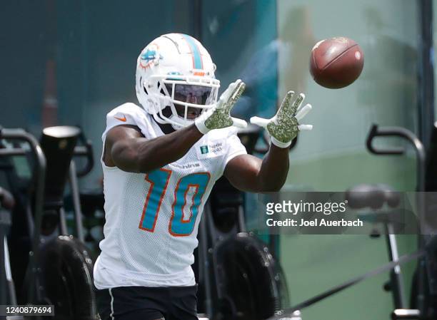 Tyreek Hill of the Miami Dolphins catches the ball during the Miami Dolphins OTAs at the Baptist Health Training Complex on May 24, 2022 in Miami...