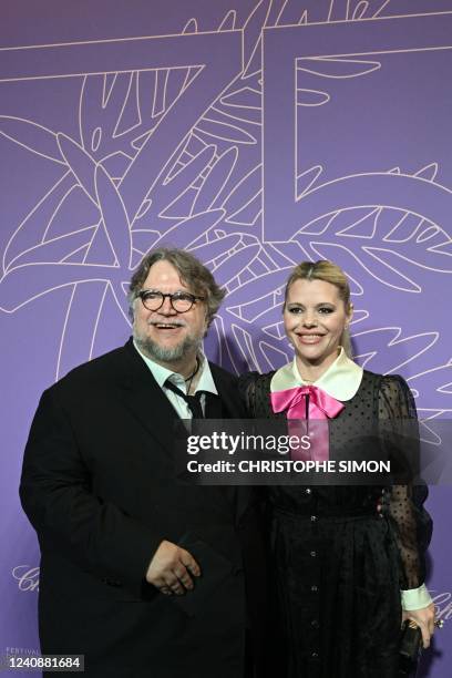 Mexican director Guillermo Del Toro and screenwriter Kim Morgan arrive for the "Cannes 75 Anniversary Dinner" during the 75th edition of the Cannes...
