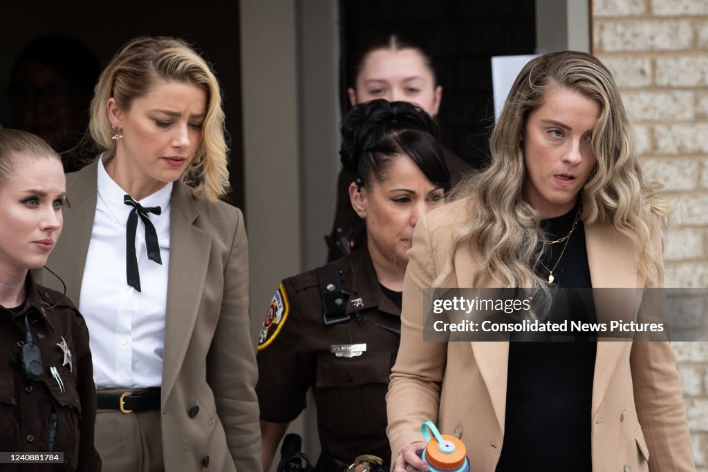 Amber Heard, left, and her sister Whitney Heard, right, depart... News