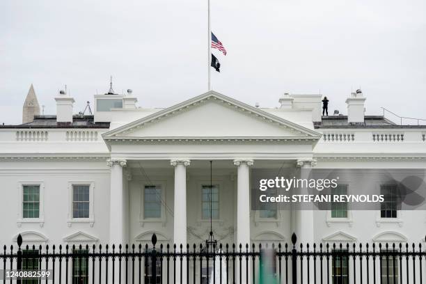 The US flag on the White House is seen flown at half-mast in Washington DC, as a mark of respect for the victims of the shooting at Robb Elementary...