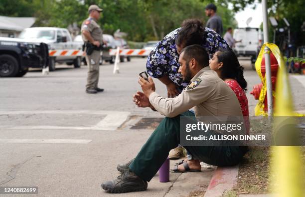 Deputy sheriff Felix Rubio, who lost his daughter, Alexandria Rubio in the mass shooting, checks his phone as he sits by his wife Kimberly on the...