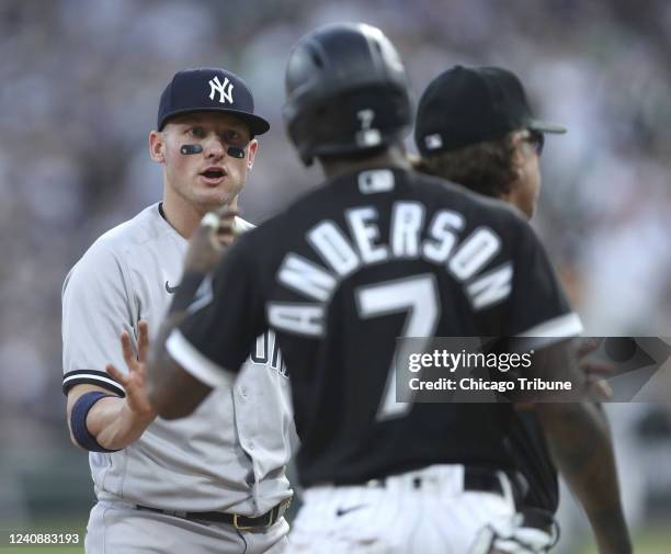 New York Yankees third baseman Josh Donaldson, left, and Chicago White Sox baserunner Tim Anderson exchange words in the first inning on May 13 at...