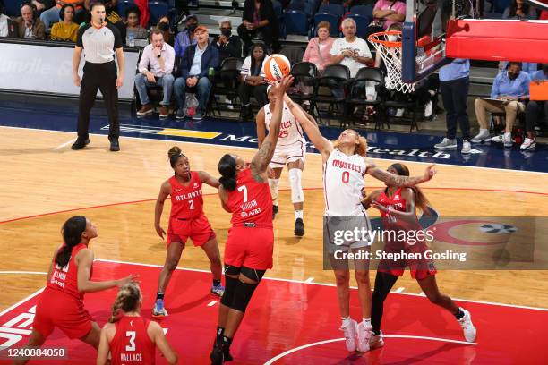 Kia Vaughn of the Atlanta Dream and Shakira Austin of the Washington Mystics move the ball during the game on May 24, 2022 at Entertainment & Sports...